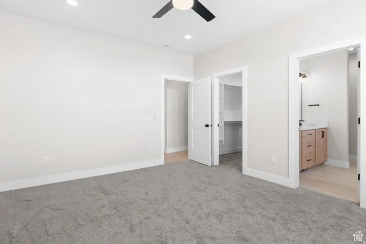 Plush carpet flooring, recessed lighting, and a ceiling fan