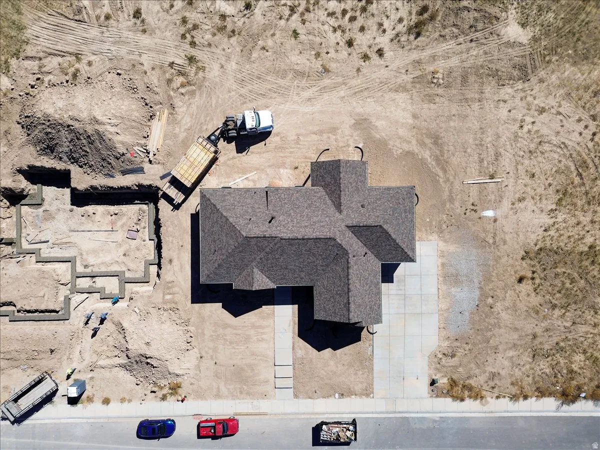 Newly constructed property featuring a multi-gabled roofline and a concrete driveway