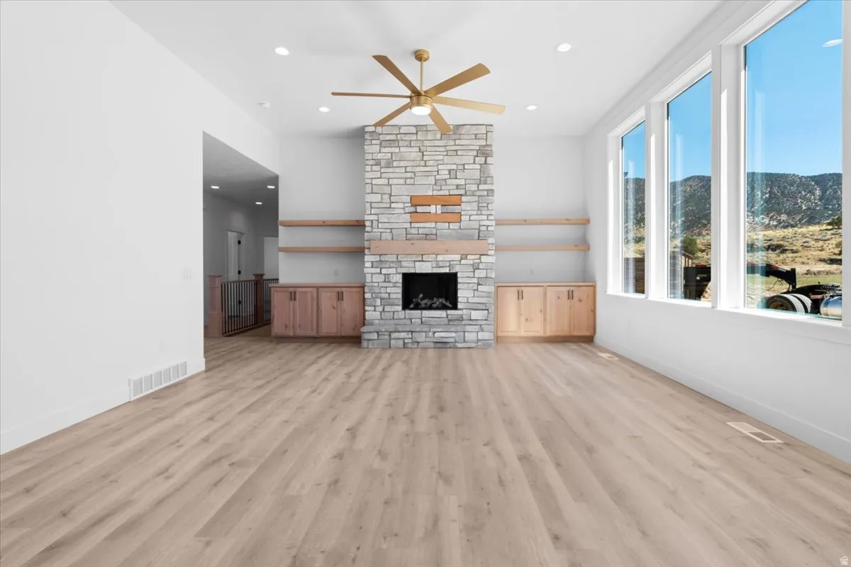 Stone-clad fireplace with a wood mantel