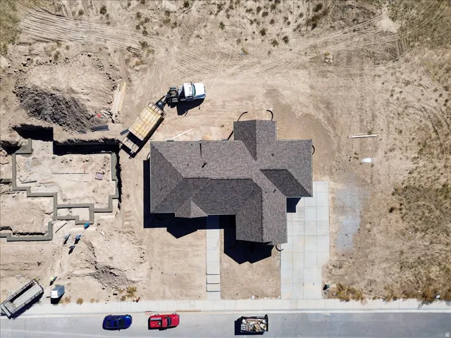 Newly constructed property featuring a multi-gabled roofline and a concrete driveway