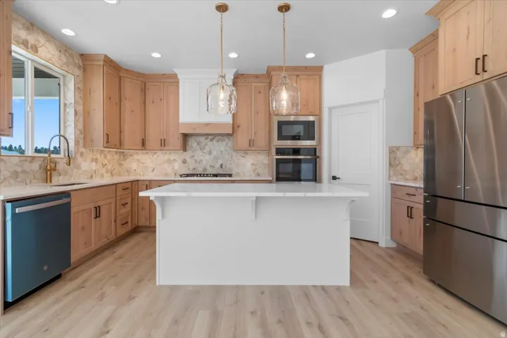 Light wood-finish flooring with a central island and white countertop