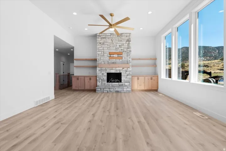 Stone-clad fireplace with a wood mantel