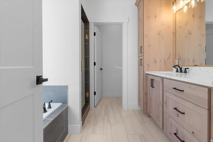 Light wood-finish cabinetry with black hardware