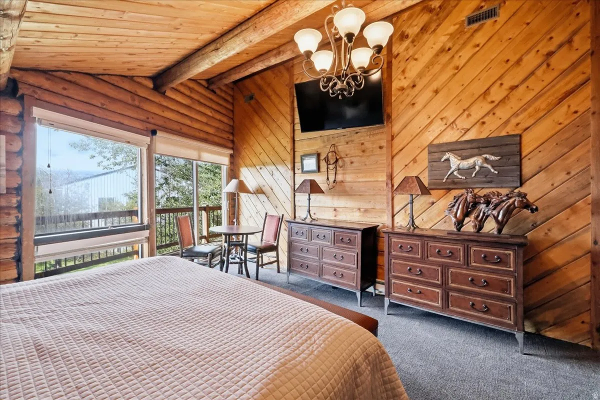 Wood-paneled walls and ceiling, large windows, and a private balcony