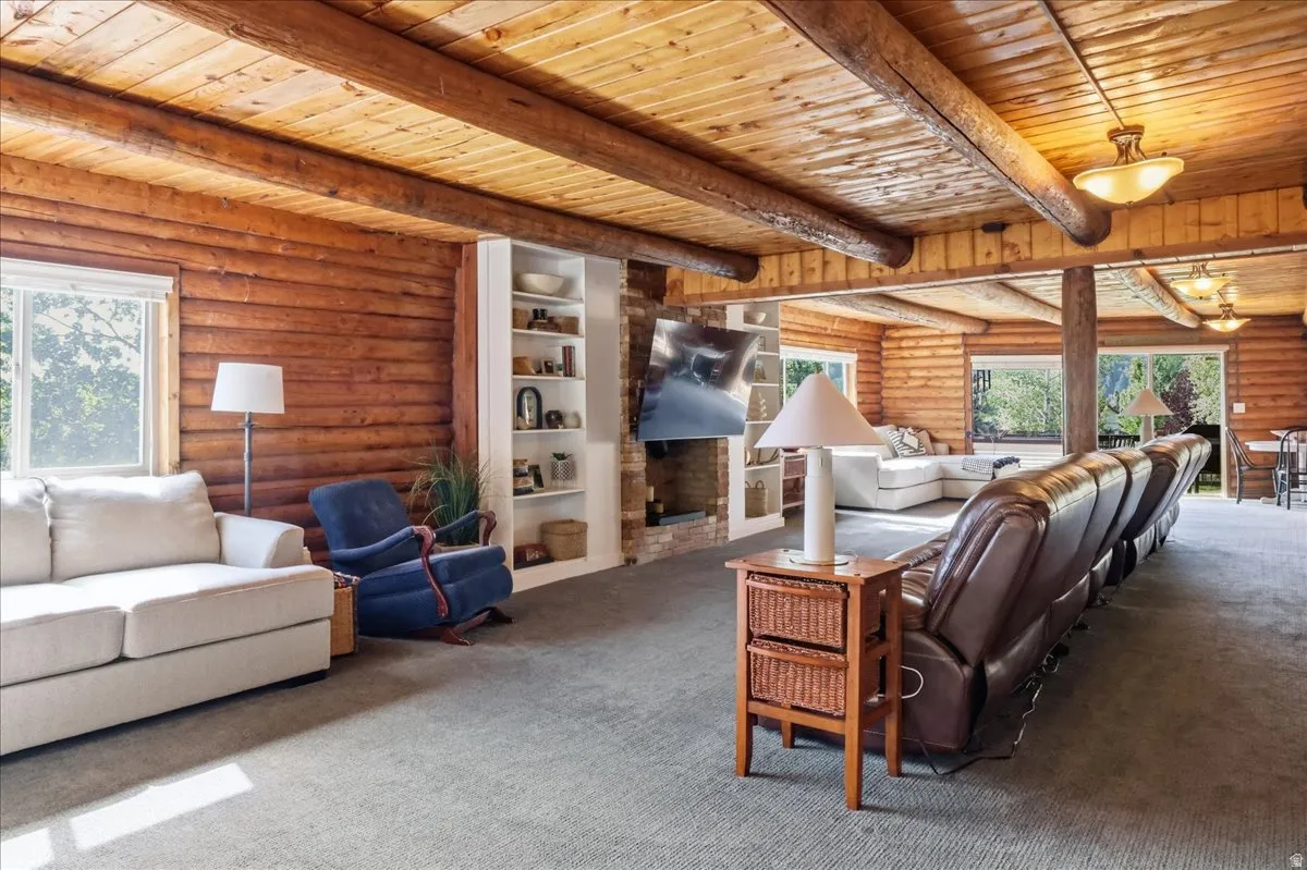 Exposed wood beam ceiling, wood plank walls, and built-in shelving