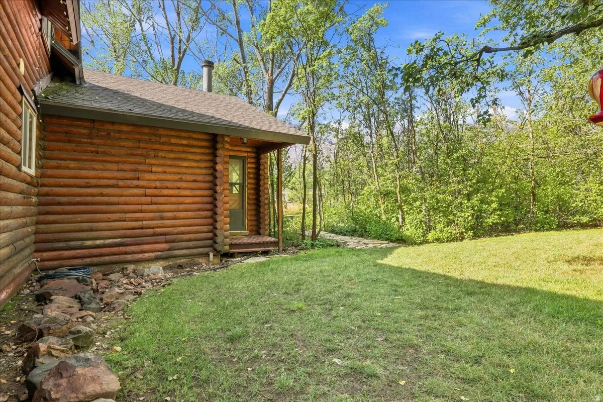 Log-style exterior with wood siding and a covered porch entry