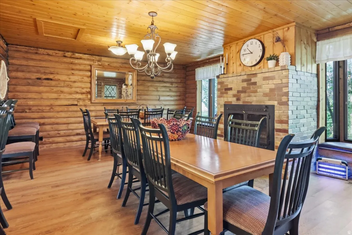 Log walls and wood-finish ceiling with a chandelier