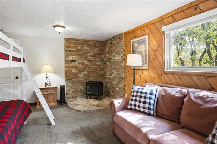 Brick accent wall with a hearth and wood-burning stove