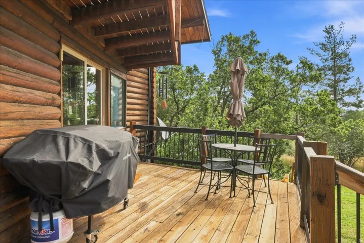 Wood deck with a black metal railing and wood posts