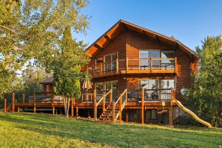 Log-sided exterior with multiple outdoor deck spaces