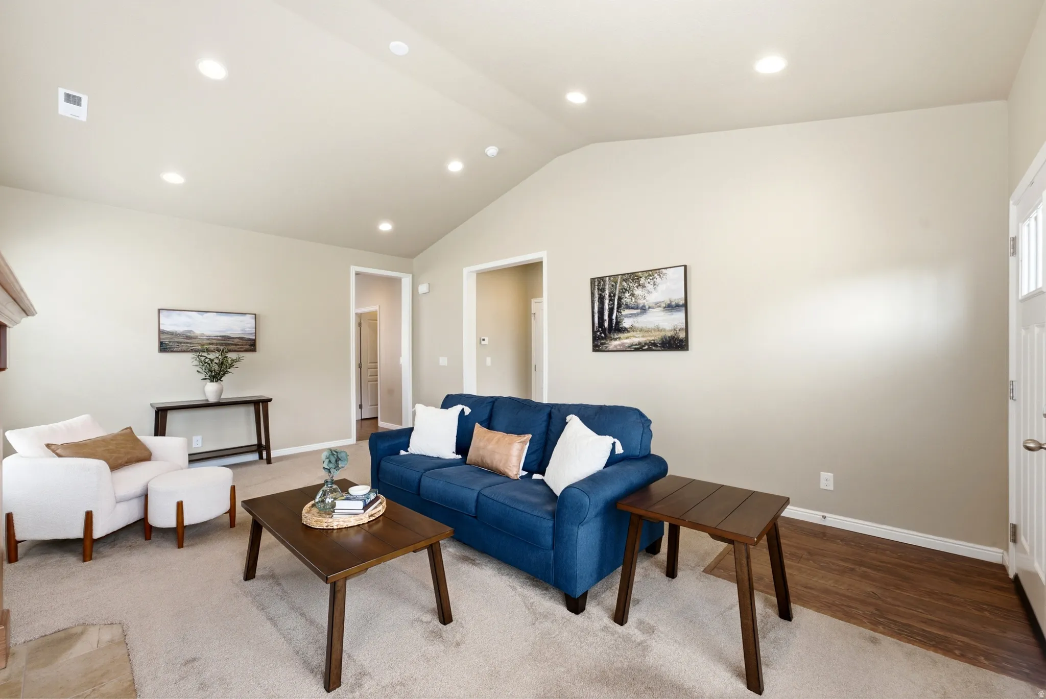 Vaulted ceiling with recessed lighting, neutral wall paint, carpeted flooring, wood-finish flooring, and a white paneled door with window inserts