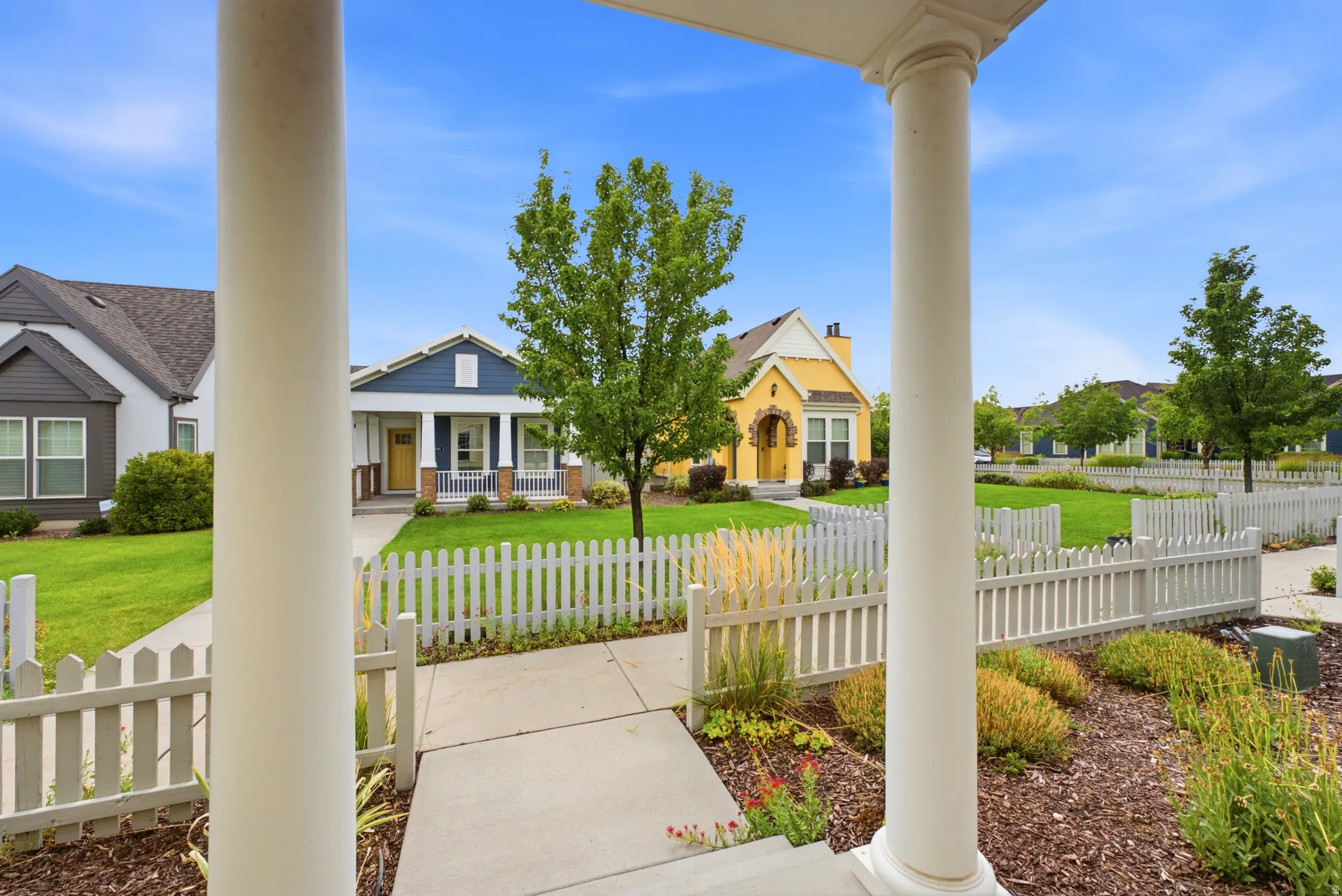 White picket fence framing the front yard