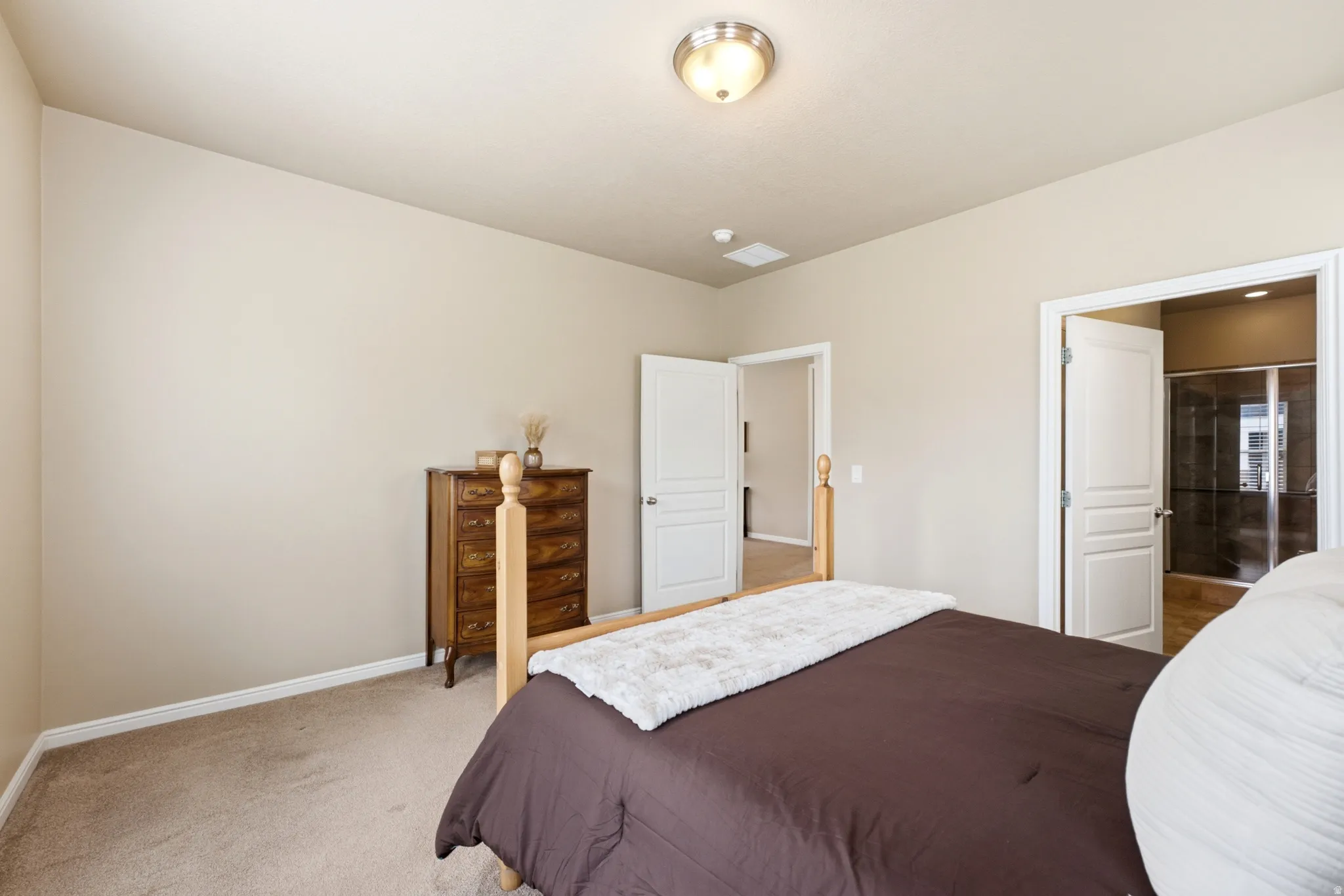 Neutral-toned walls complement plush carpeting