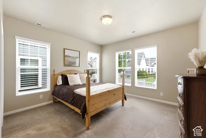Neutral wall colors, recessed lighting, and soft carpet flooring