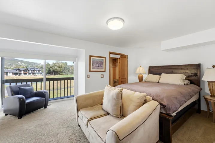 Bedroom featuring a wood bed frame, recessed ceiling light, and carpeted flooring
