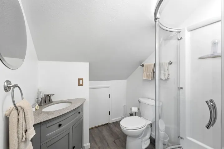 Modern vanity with a curved front, integrated sink, and granite-style countertop