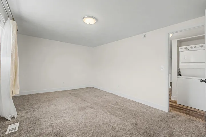 Neutral tone wall finish and carpeted flooring