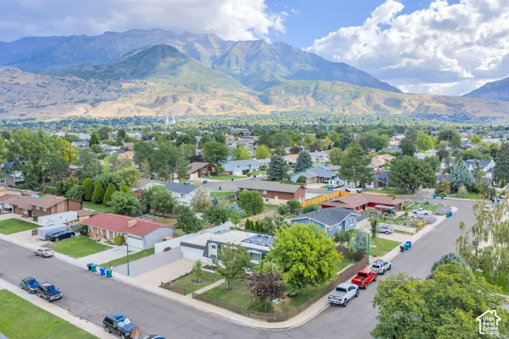 Residential neighborhood featuring mature trees and mountain scenery