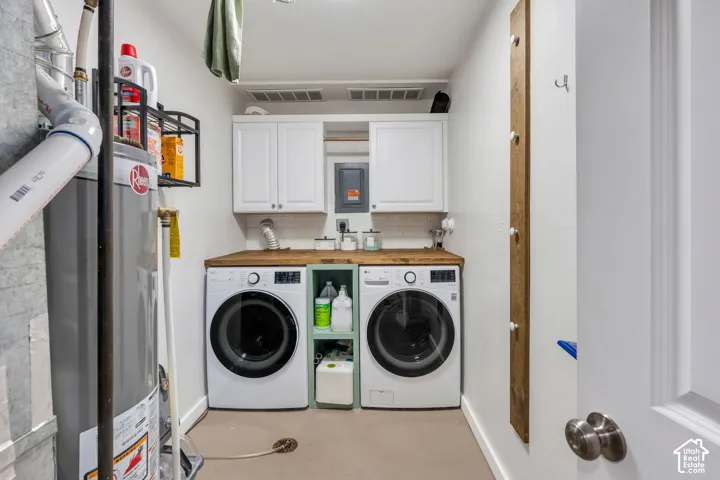 Dedicated laundry area featuring white shaker-style cabinetry, wood-finish countertops, and a white subway tile backsplash