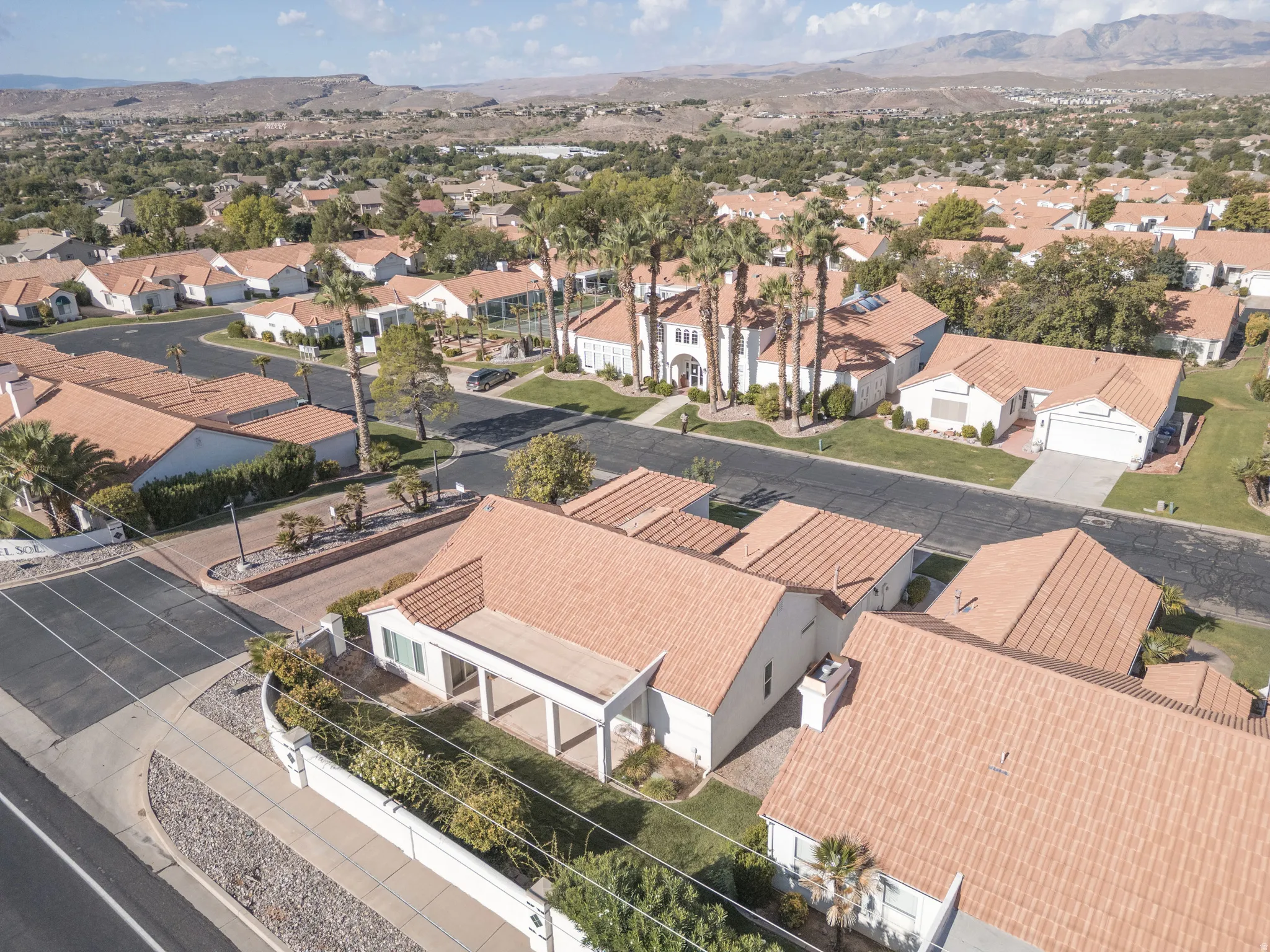 Tile roofs, mature trees, and a desert landscape
