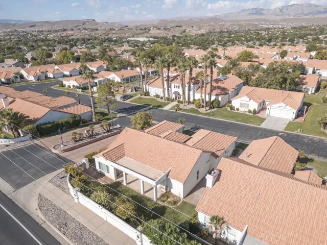 Tile roofs, mature trees, and a desert landscape