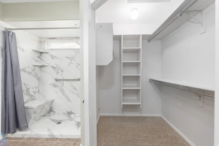 Walk-in closet with built-in shelving and hanging rods