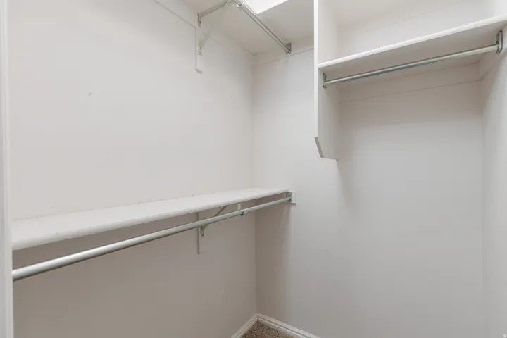 White shelving and metal hanging rods
