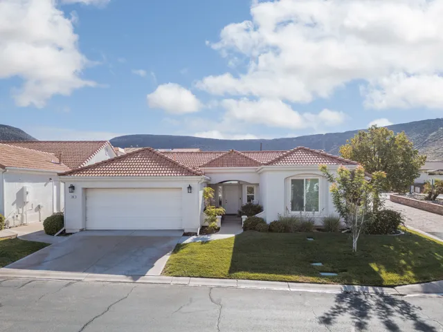 White stucco exterior with a terracotta tile roof