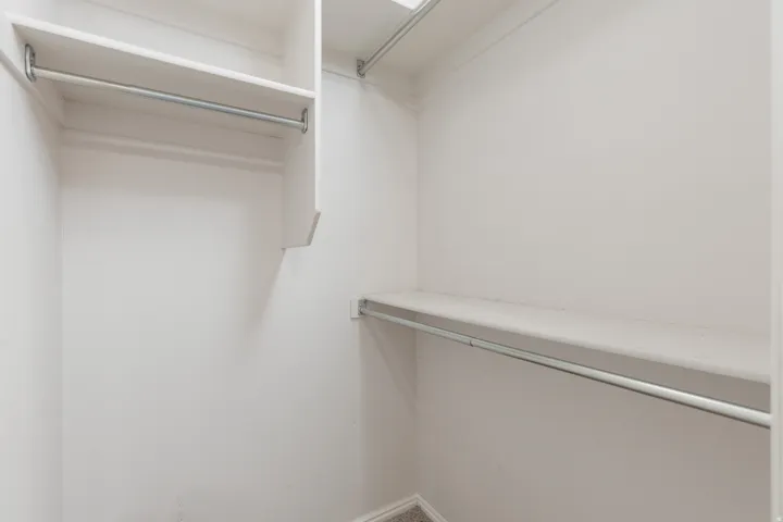 White built-in shelving and hanging rods