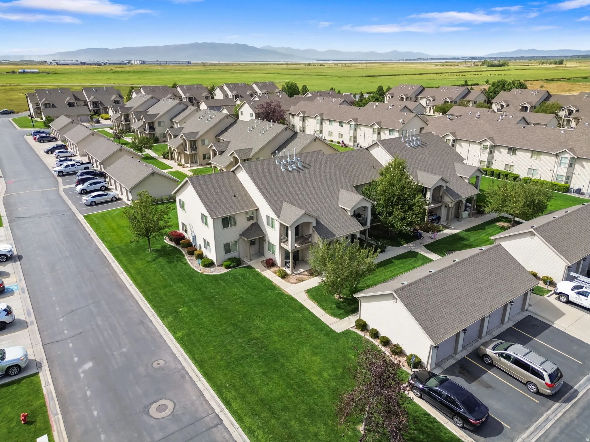 Expansive green spaces and mature landscaping complement the property exteriors