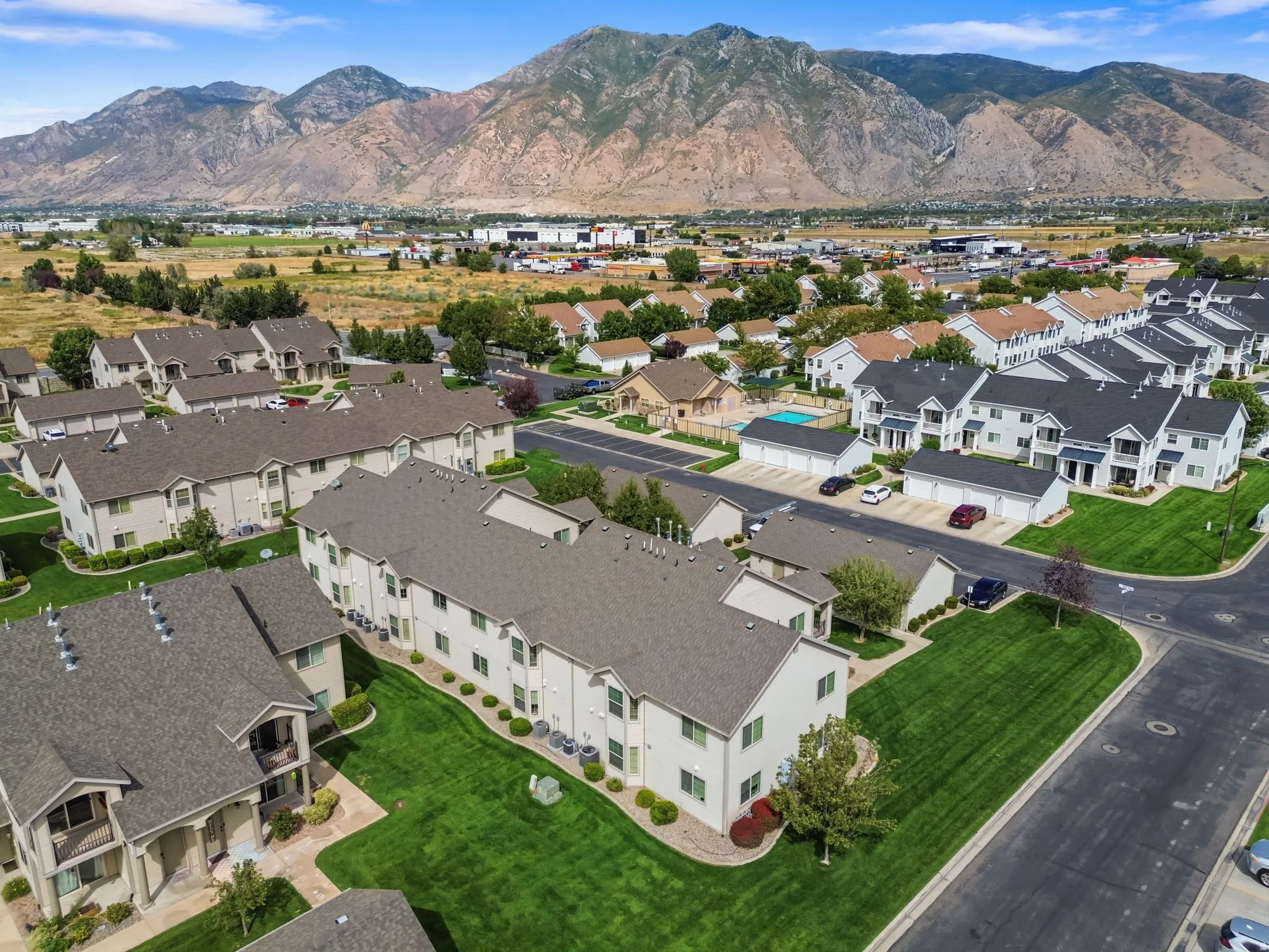 Townhome community with extensive green spaces and mountain backdrop
