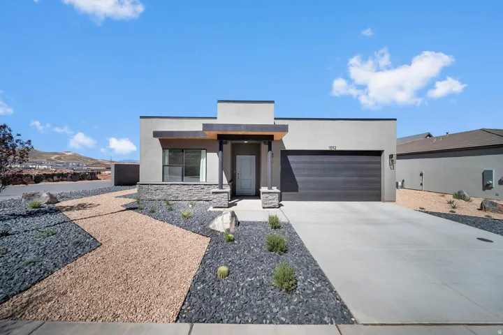 ** All Photos are of a similar home and finishes**Modern exterior featuring a flat roofline, integrated garage, and a concrete driveway