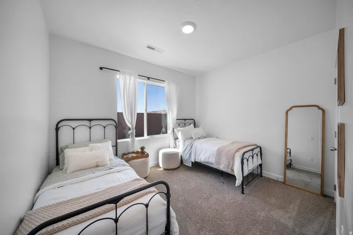 Carpeted room with a double window, recessed lighting, and white walls
