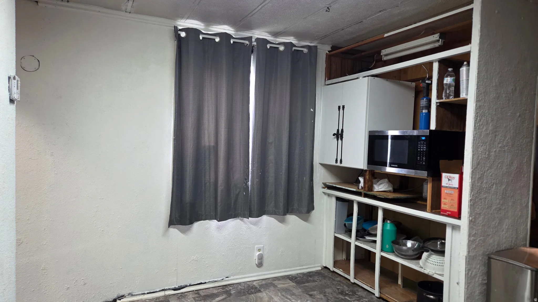 Built-in shelving unit with an integrated microwave space and upper cabinetry