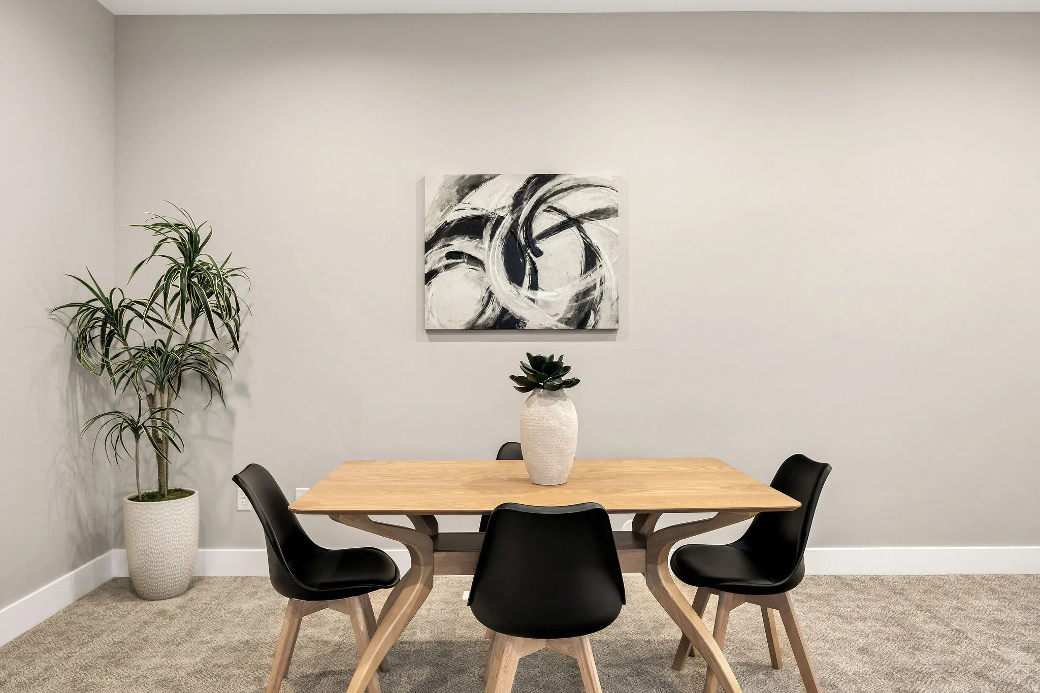 Light-toned walls, textured carpet flooring, and white baseboards