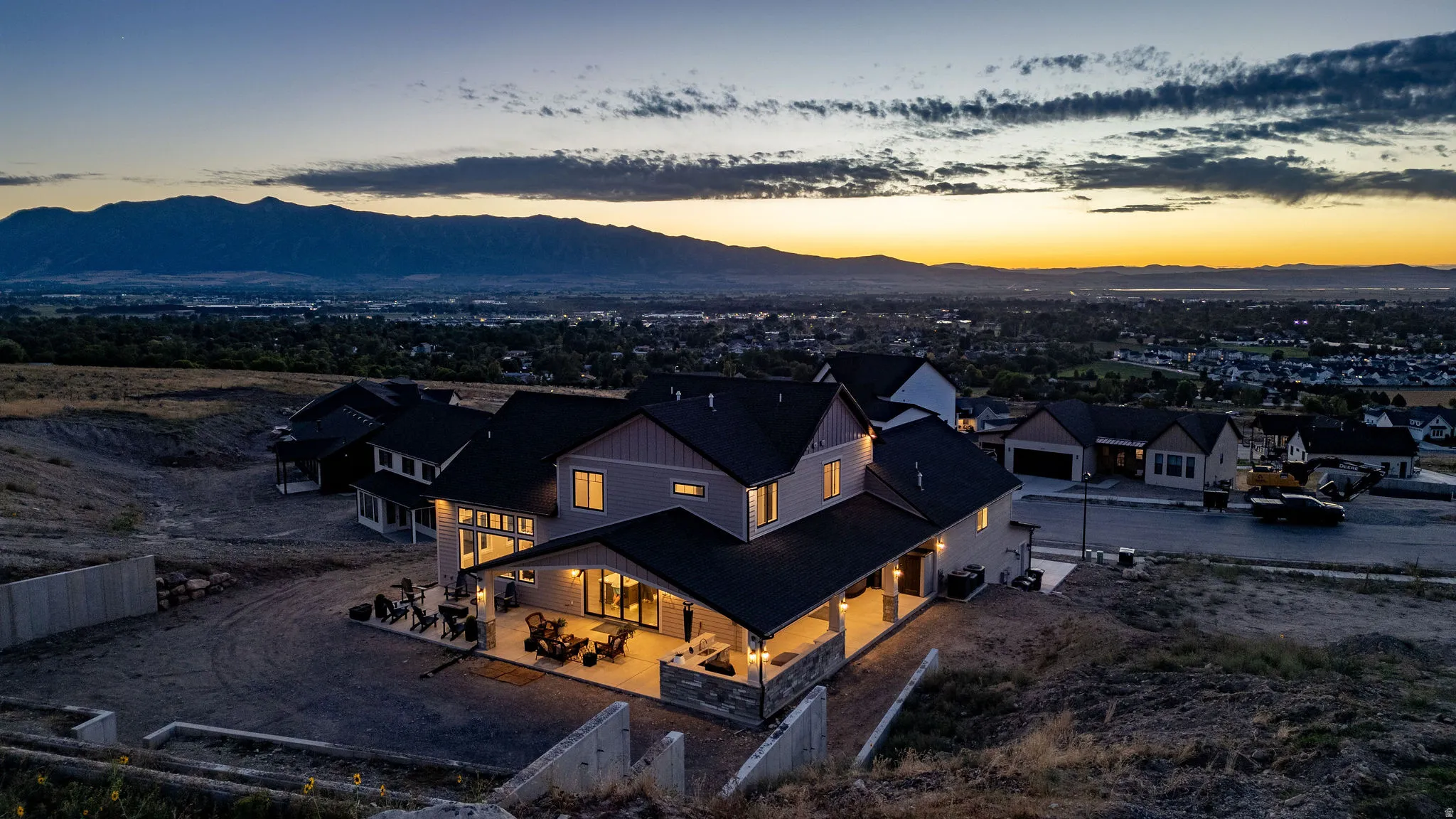 Expansive property featuring a multi-level structure, covered outdoor patio, and integrated lighting