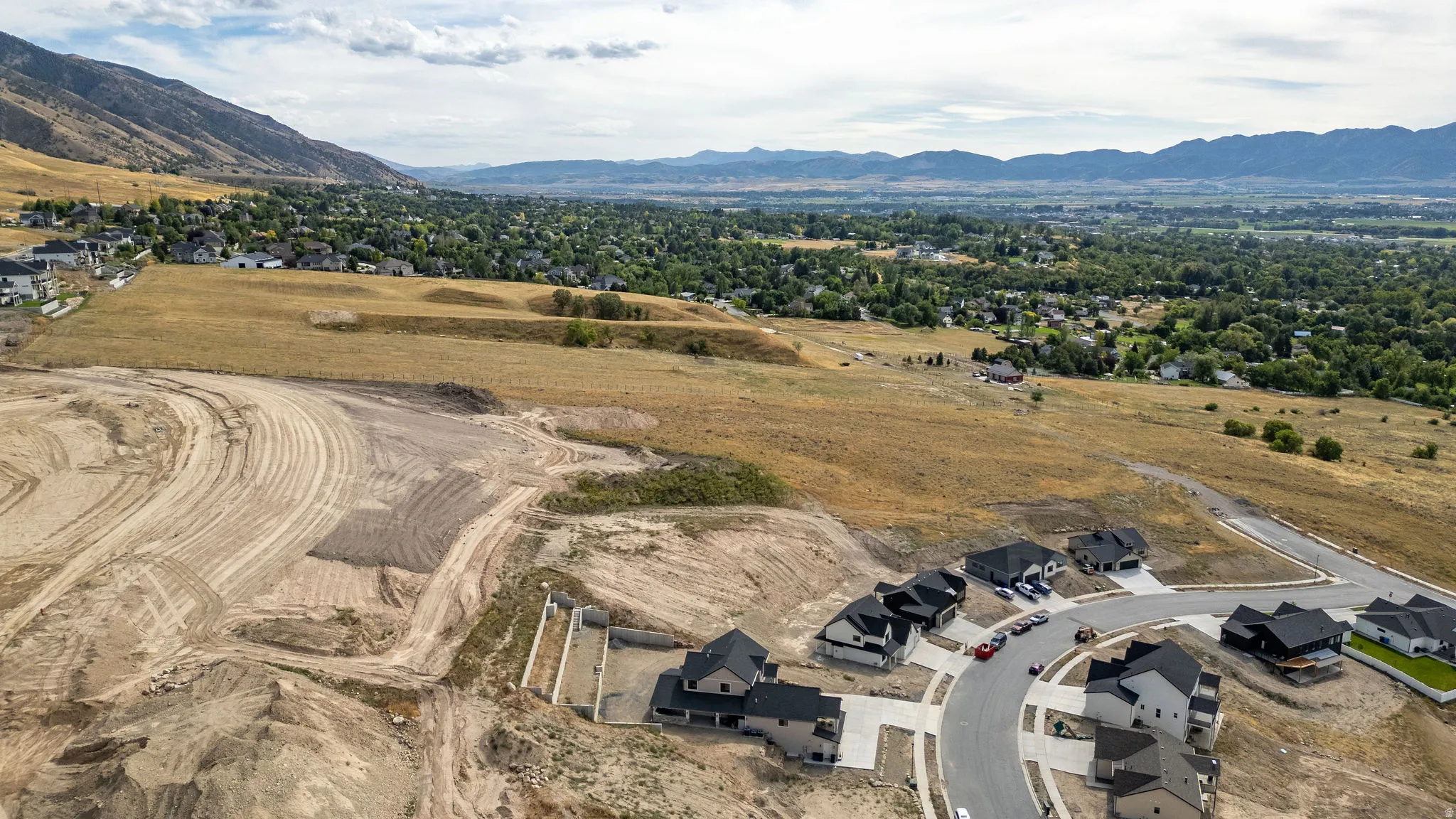 Expansive undeveloped land with visible grading