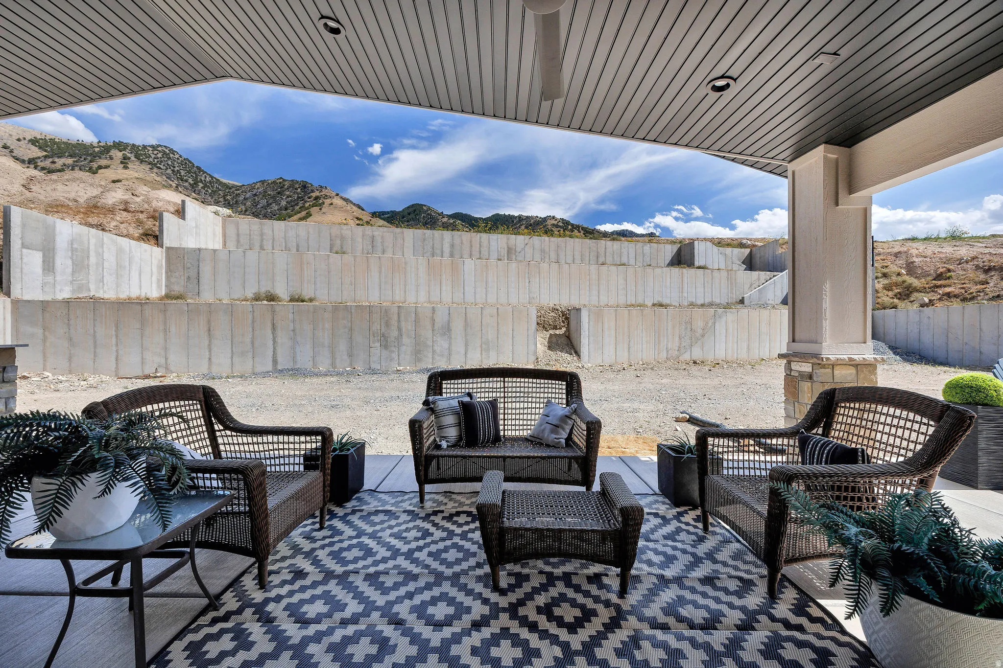 Covered patio with a slatted ceiling and integrated lighting