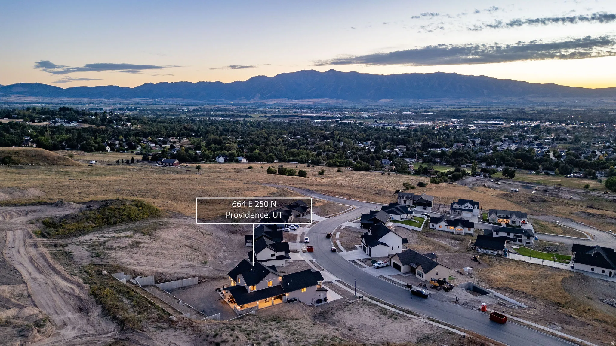 Aerial perspective of a developing residential area with paved streets and established homes