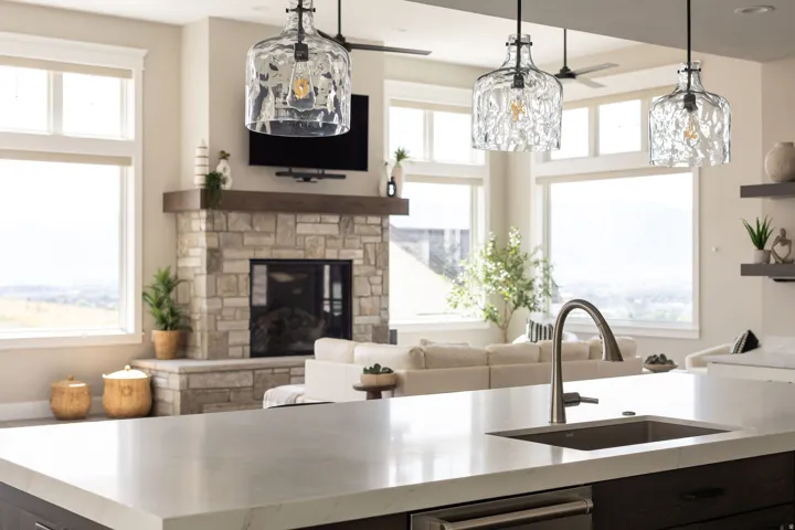 Kitchen island with an undermount sink, gooseneck faucet, and light-toned countertop