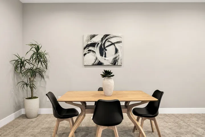 Light-toned walls, textured carpet flooring, and white baseboards