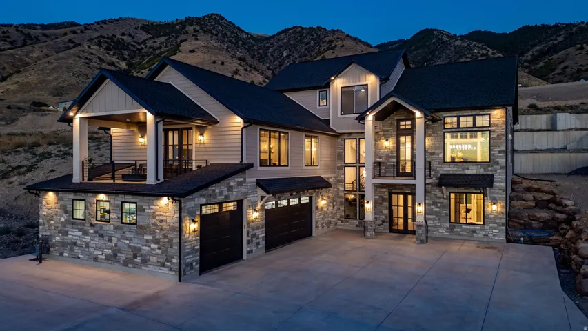 Stone and siding exterior with dark trim accents