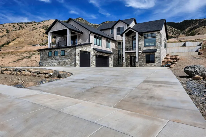 Contemporary architectural style featuring stone veneer and horizontal siding