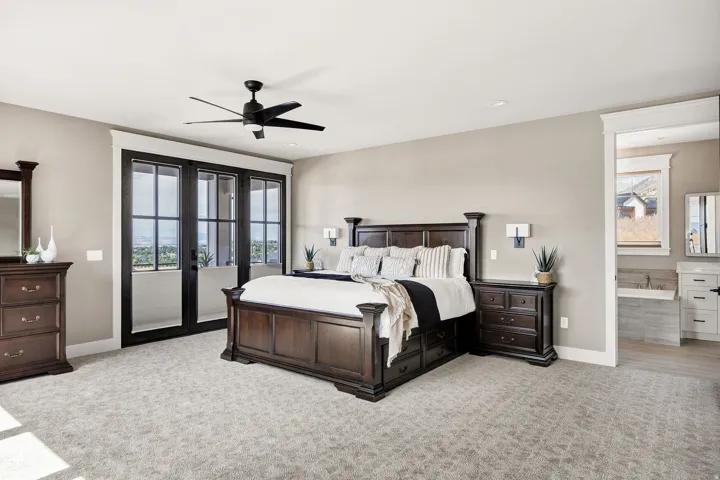 Recessed lighting, ceiling fan with light, sconce lighting, French doors, and soft carpeting
