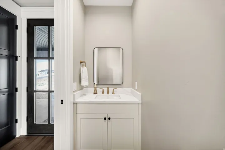 White shaker-style vanity with a white countertop and rectangular undermount sink