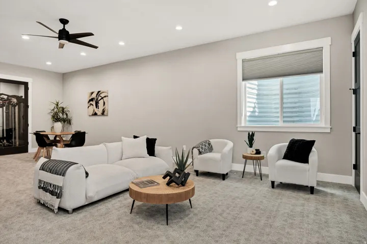 Recessed lighting, ceiling fan, and carpeted flooring in a versatile living space