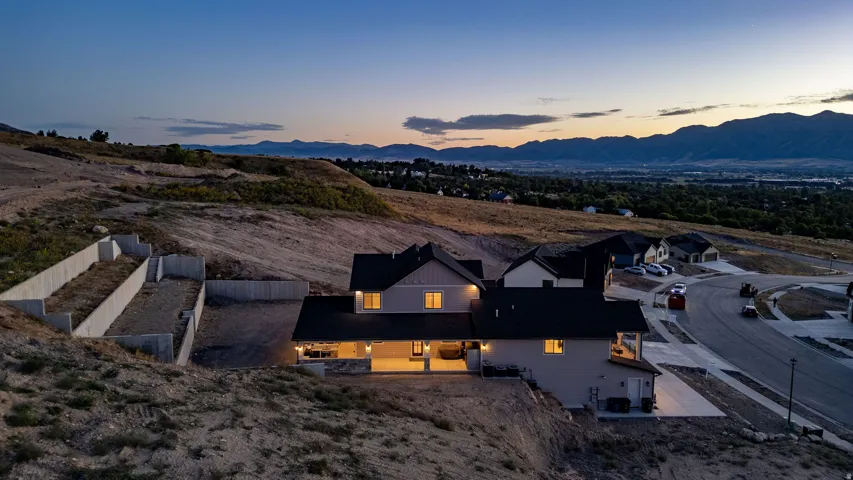 Contemporary two-story residence with a dark-pitched roof and light-toned siding