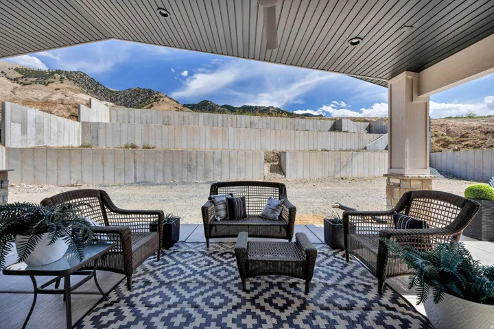 Covered patio with a slatted ceiling and integrated lighting