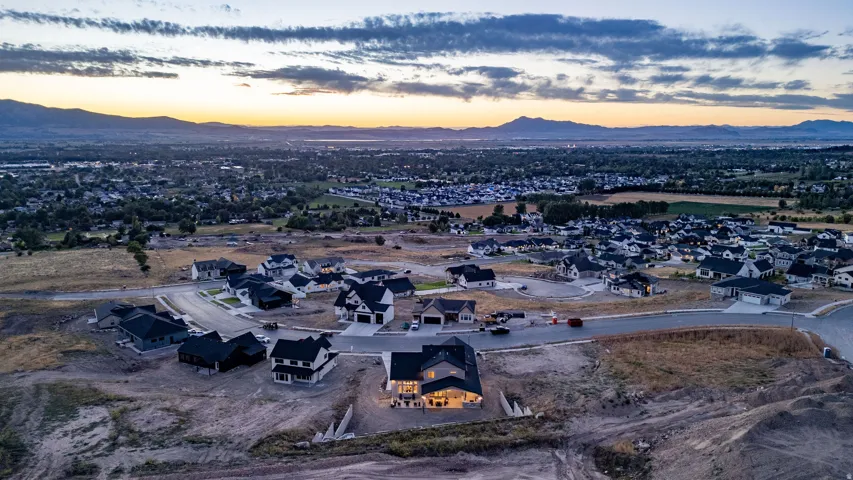 New construction residential development featuring a mountain backdrop and extensive community infrastructure