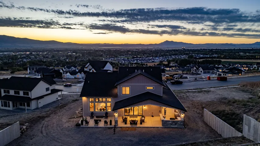 Contemporary residence with multiple windows, covered patio, and stone detailing